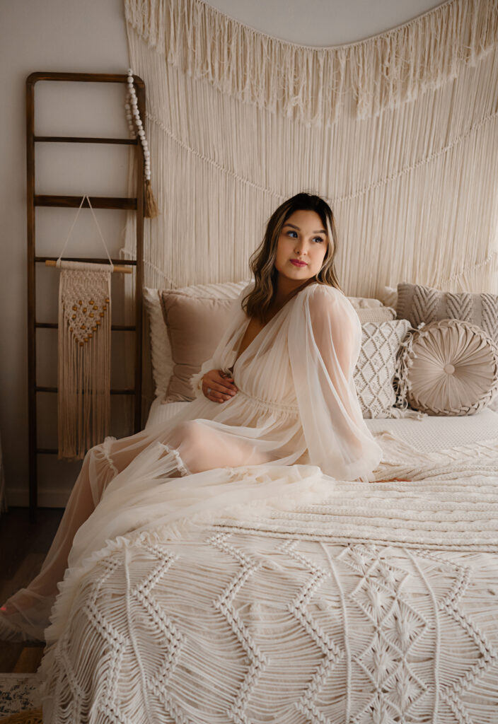 Maternity image of a client sitting in a flowing dress, by Fort Worth Photographer Paula Goforth 