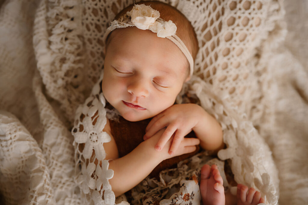 Swaddled newborn in adorable bohemian styling. Image by Fort Worth photographer Paula Goforth 