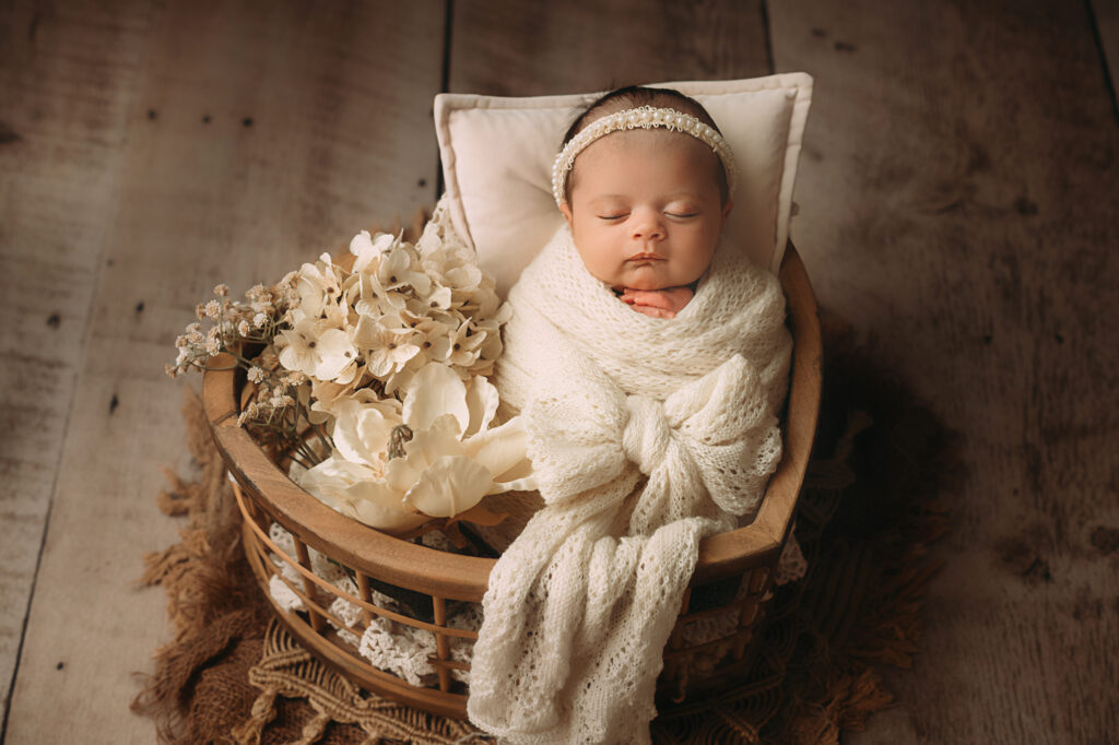 Sweet swaddled baby in beige wrap. Fort Worth Photographer Paula Goforth 