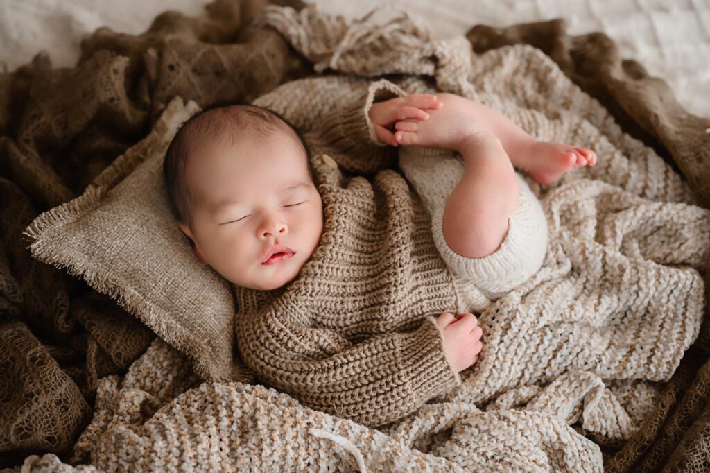 Newborn image of baby wrapped in a swaddle by newborn photographer Paula Goforth in Fort Worth Texas