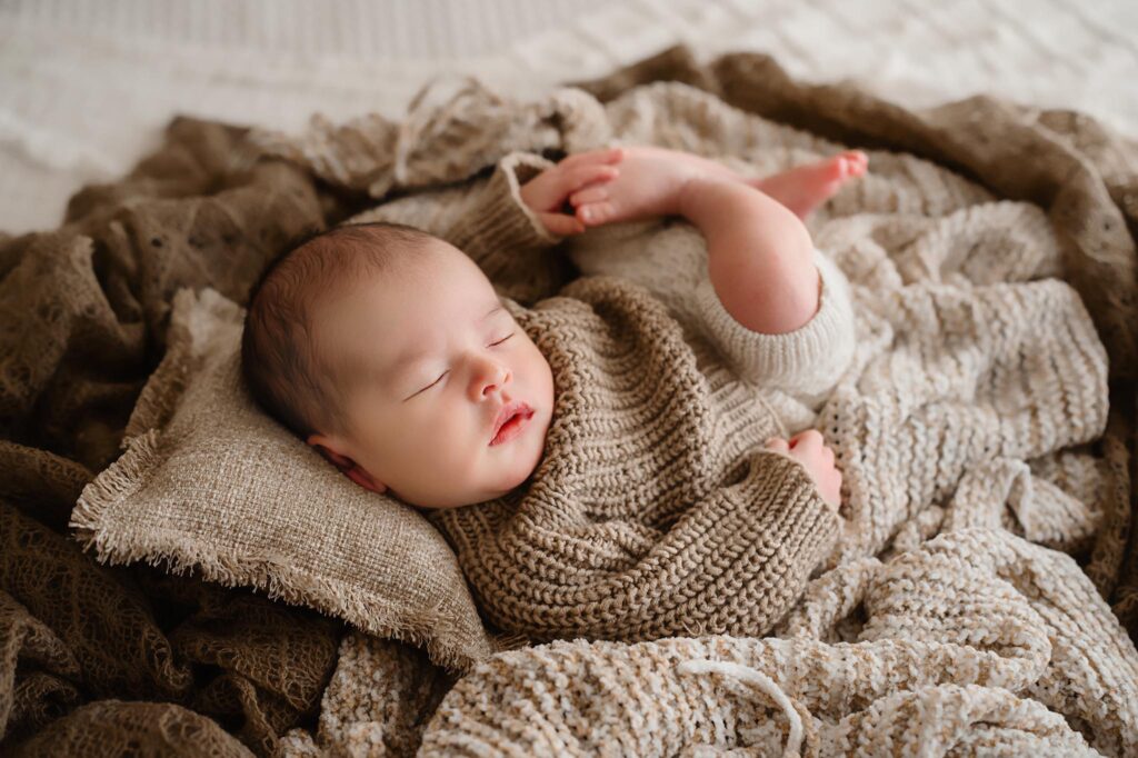 Newborn image of baby wrapped in a swaddle by newborn photographer Paula Goforth in Fort Worth Texas