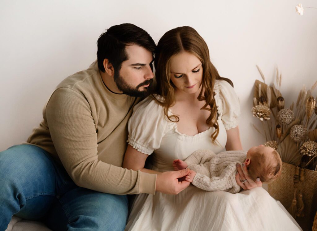 Mom and dad and baby neutral theme image by Fort Worth newborn photographer Paula Goforth