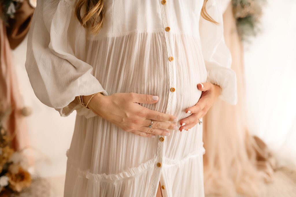 Beautiful maternity portrait of expectant mom in cream dress by Paula Goforth in Fort Worth Texas