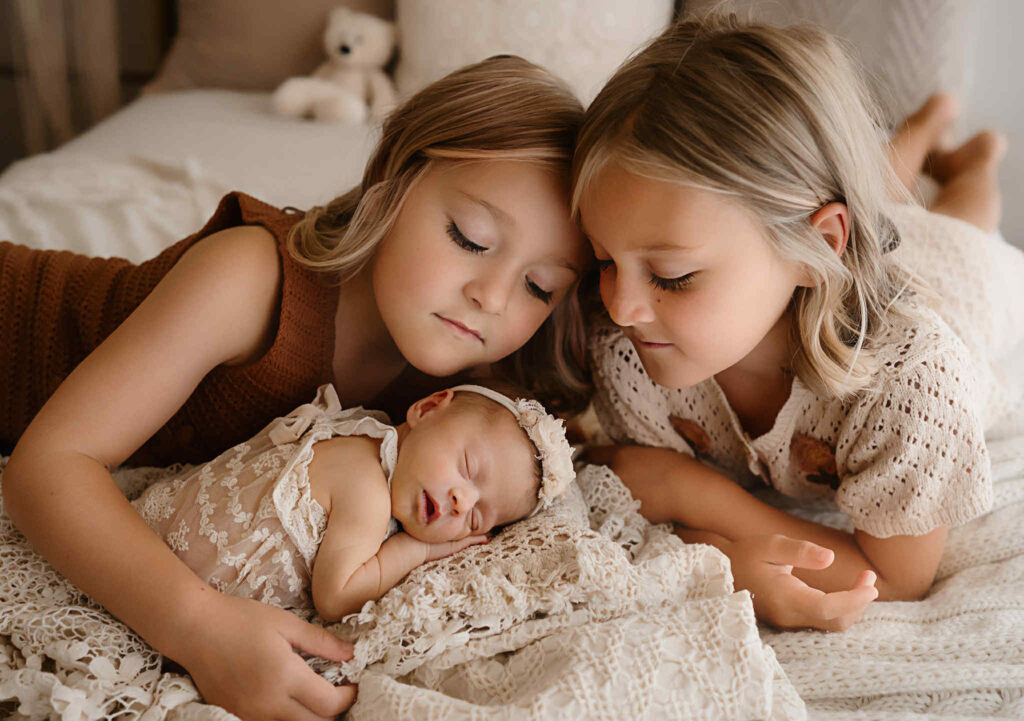 Natural, soft newborn portraits captured during the postpartum season, featuring warm tones, gentle posing, and heartfelt moments between mother and baby.