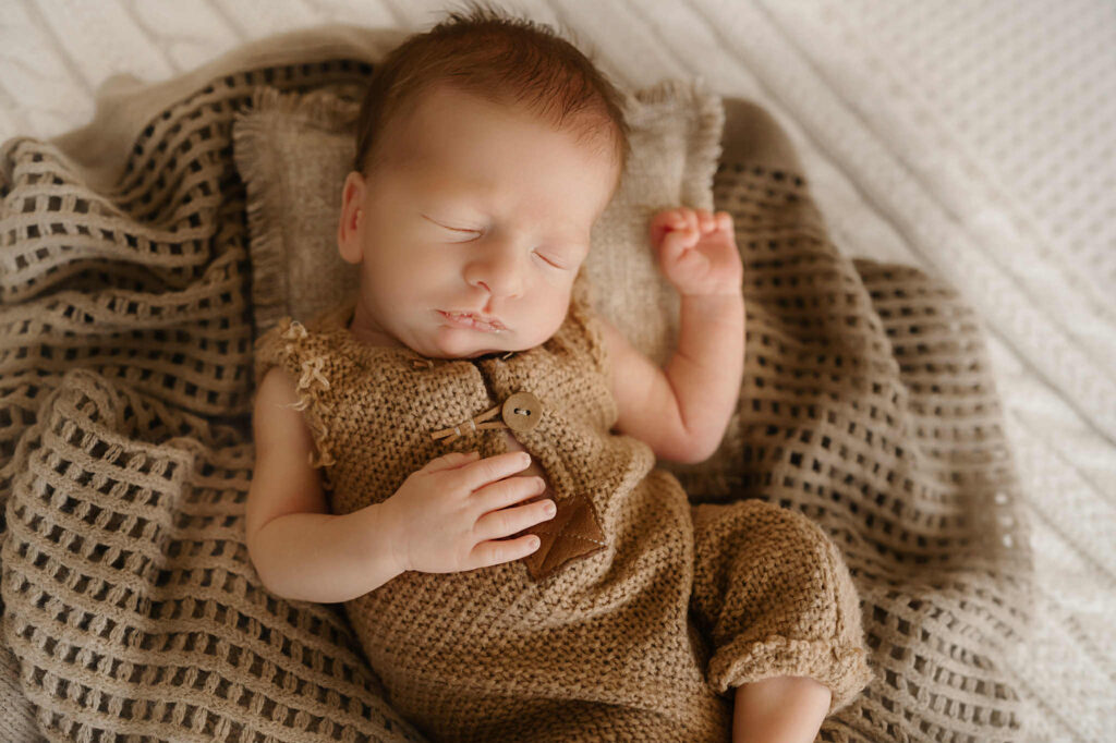 Newborn twin boys swaddled in neutral blankets during a Fort Worth photography session