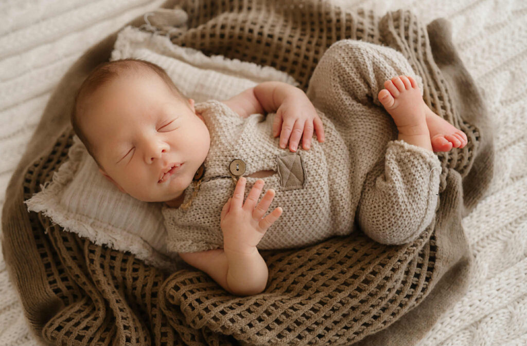 Newborn twin boys swaddled in neutral blankets during a Fort Worth photography session