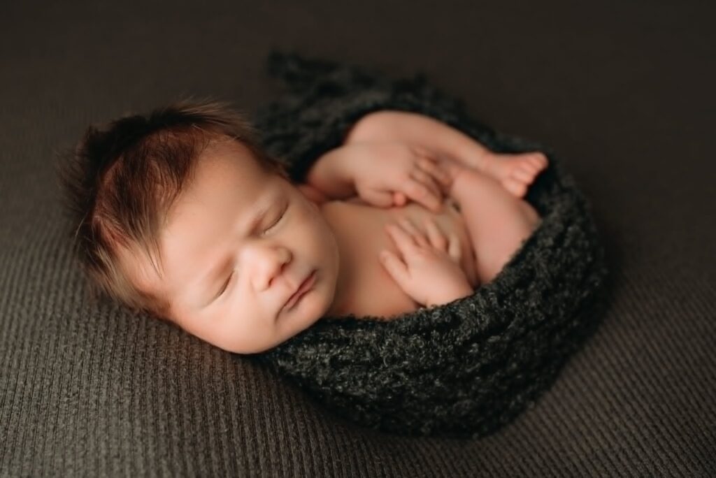 Fort Worth newborn photographer soothing baby during session