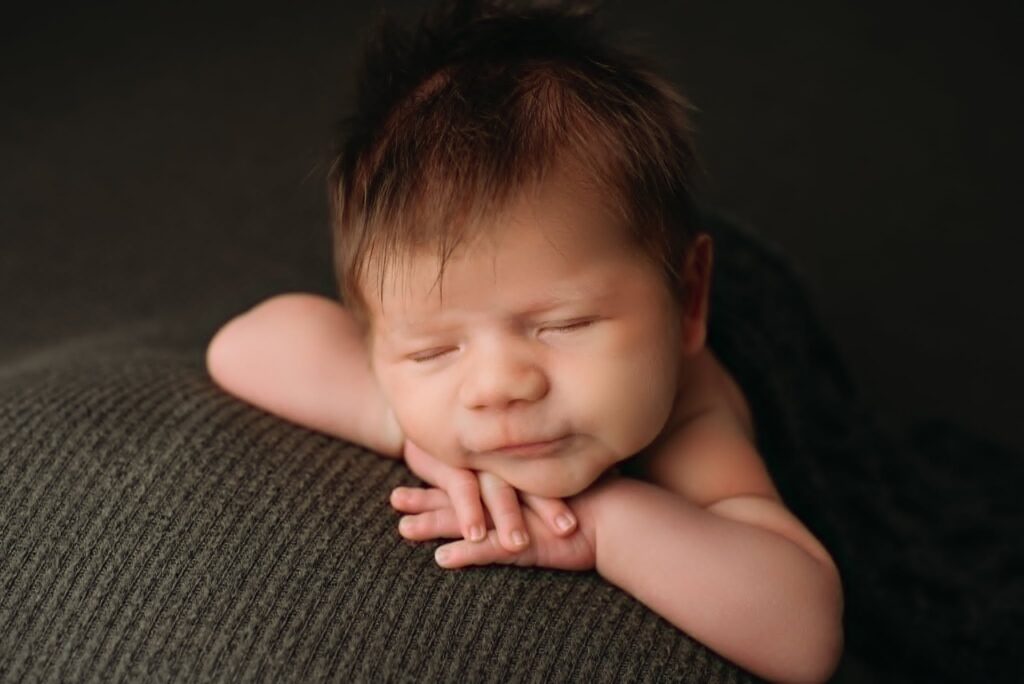 Fort Worth newborn photographer soothing baby during session